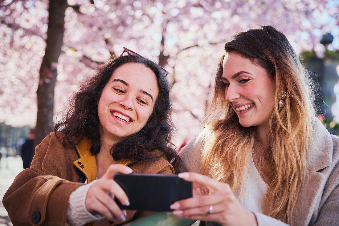 Smiling young women taking selfie