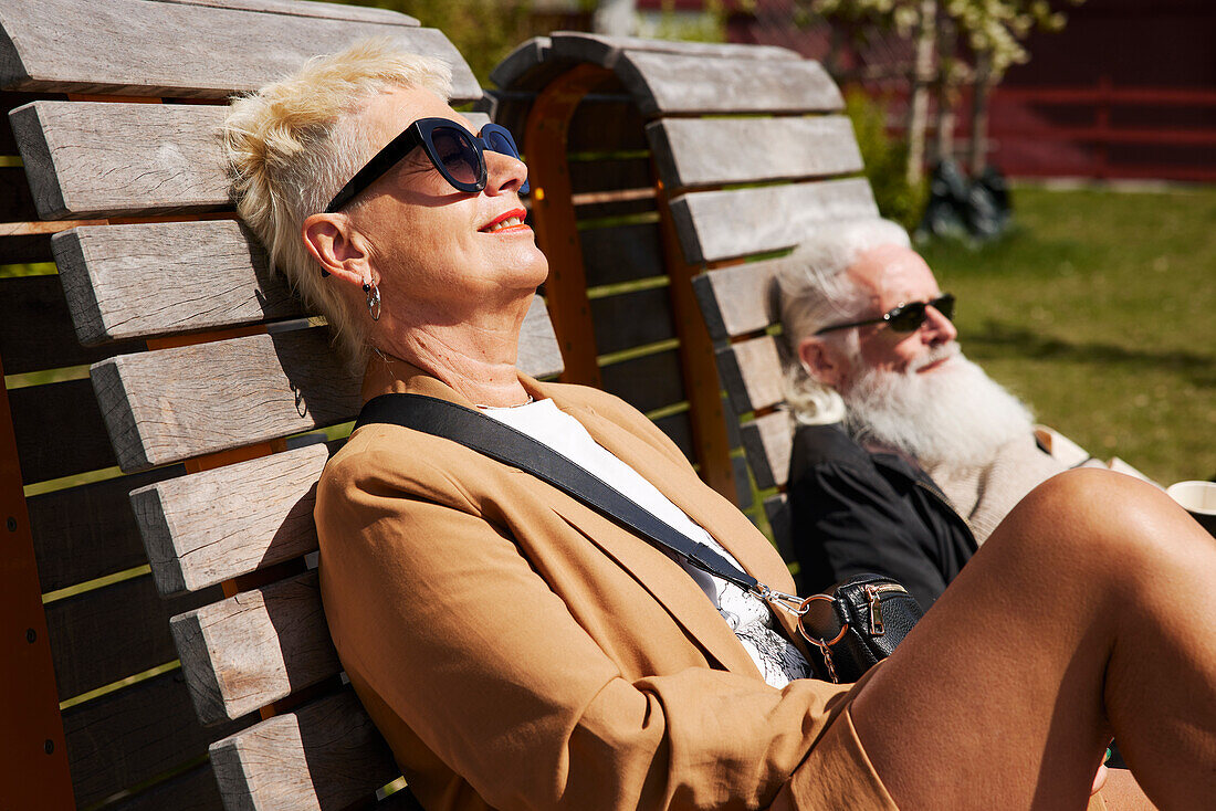 Mature woman relaxing on bench