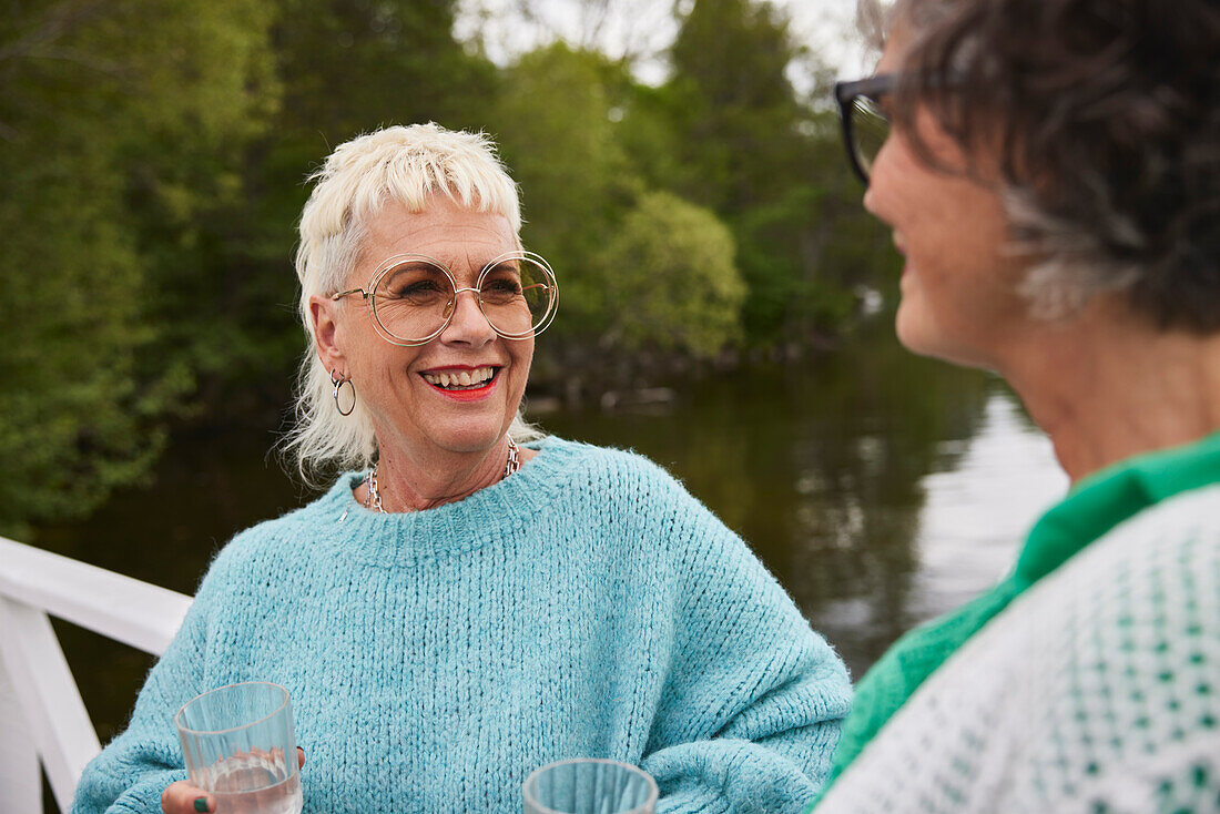 Smiling woman talking to friend