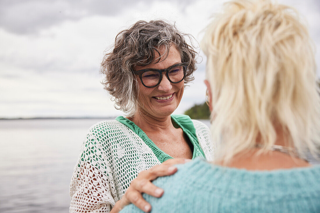 Smiling woman talking to friend