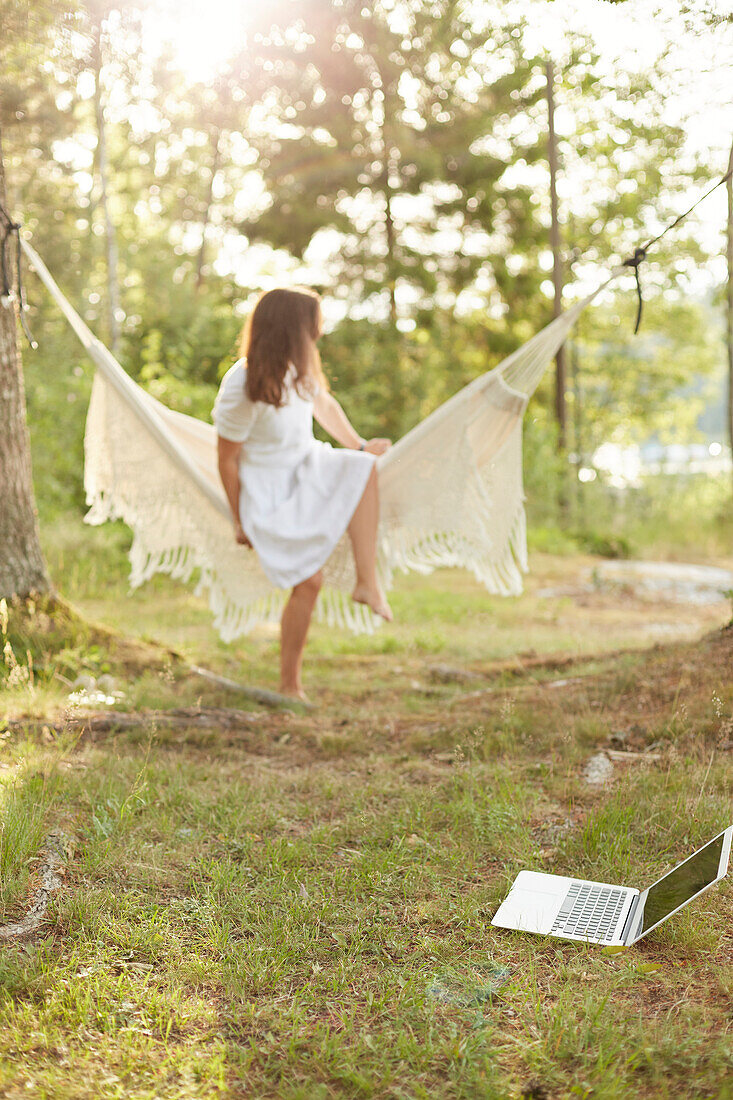 Woman relaxing in hammock