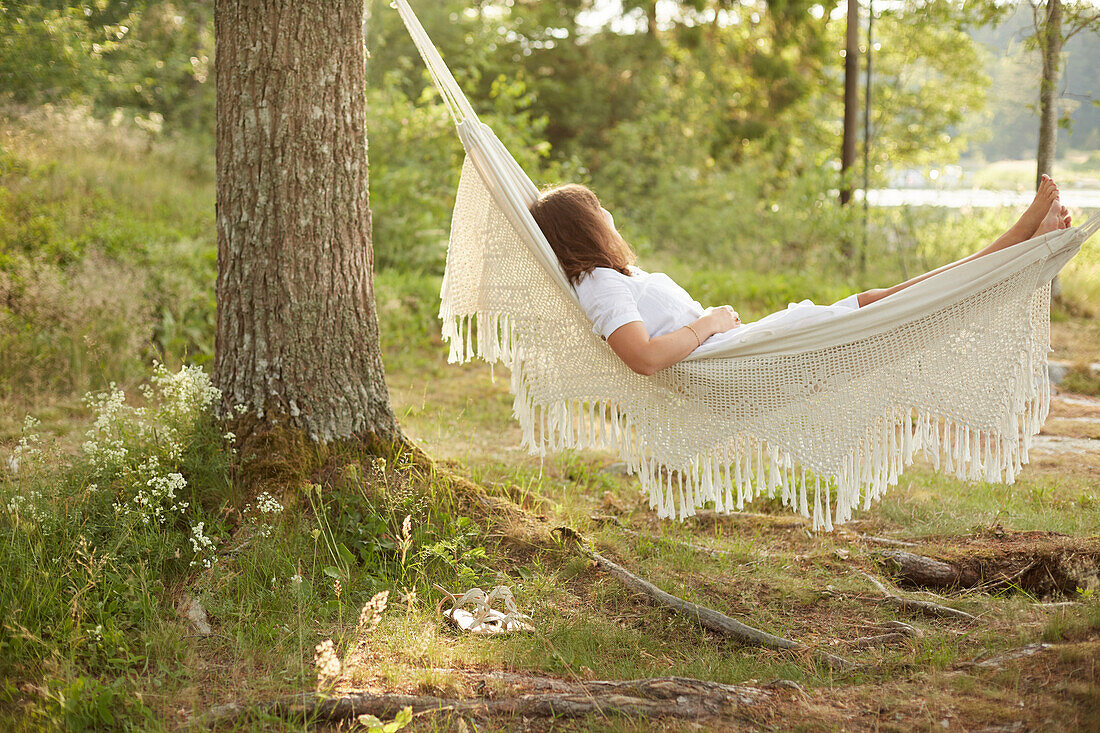 Woman relaxing in hammock