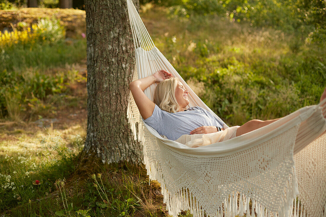 Woman relaxing in hammock