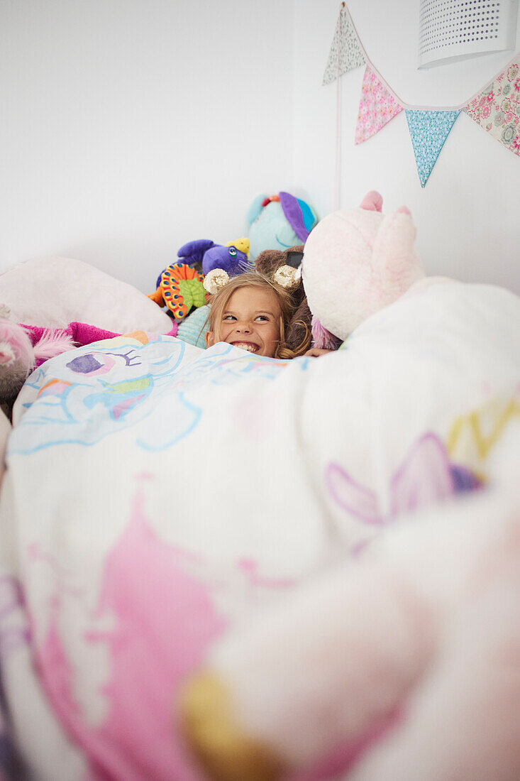 Smiling girl lying in bed