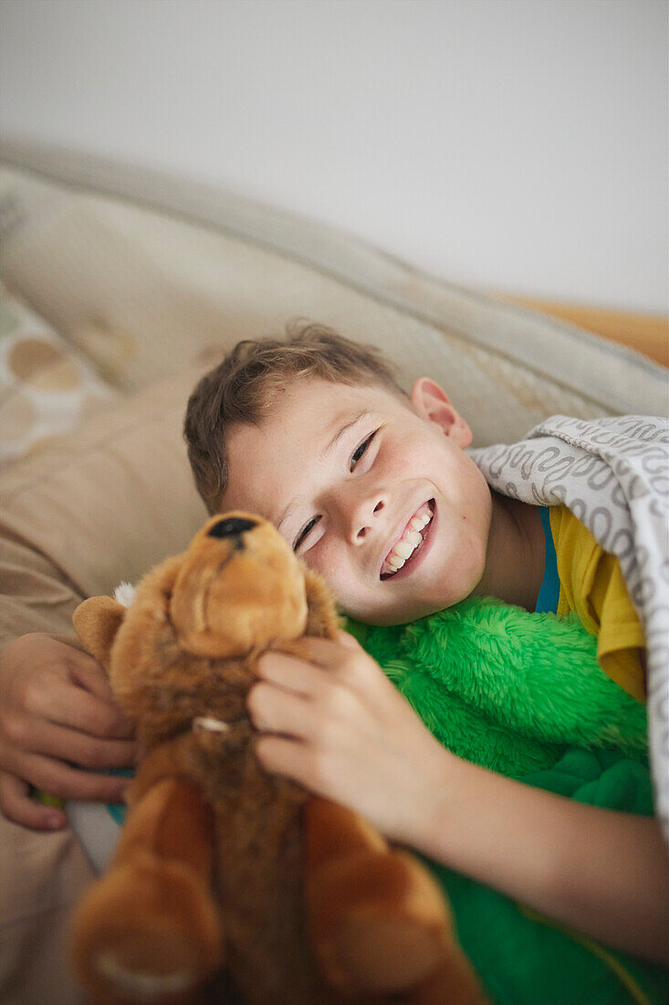 Portrait of smiling boy holding stuffed toy