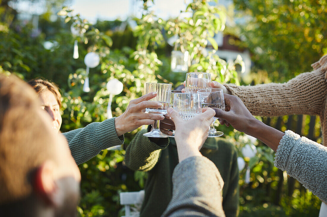 Hands with wineglasses toasting