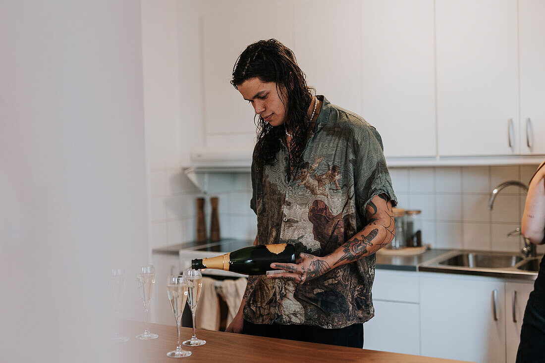 Young man pouring champagne