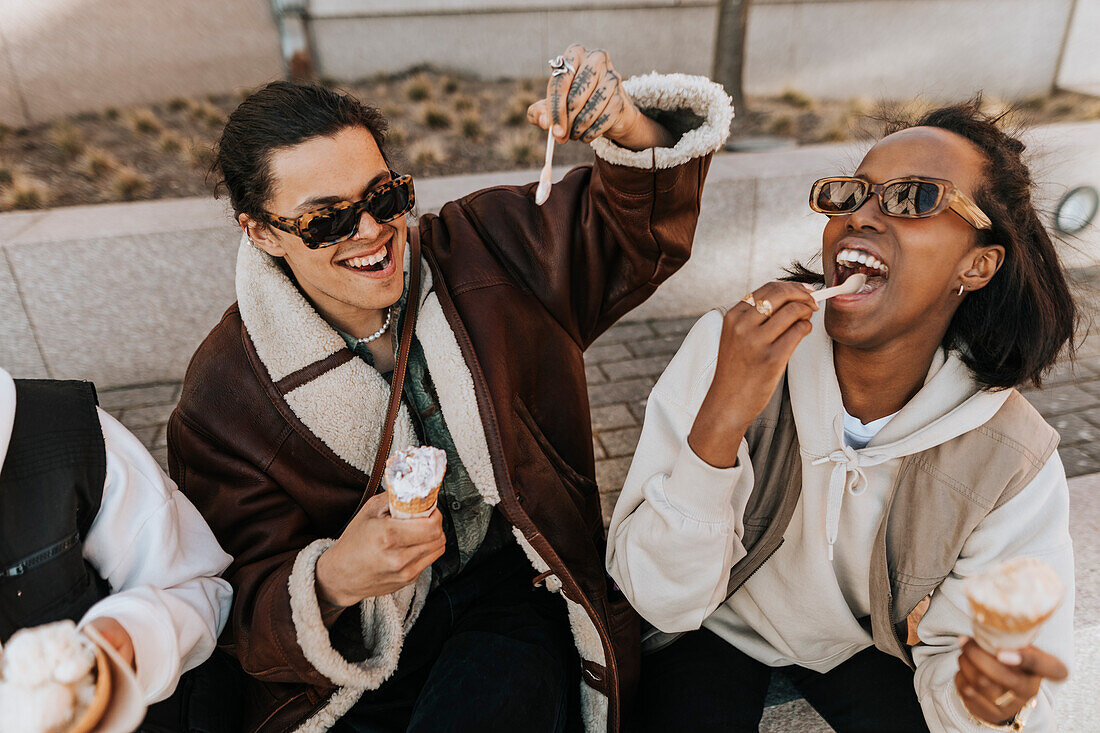 Young friends eating ice-creams