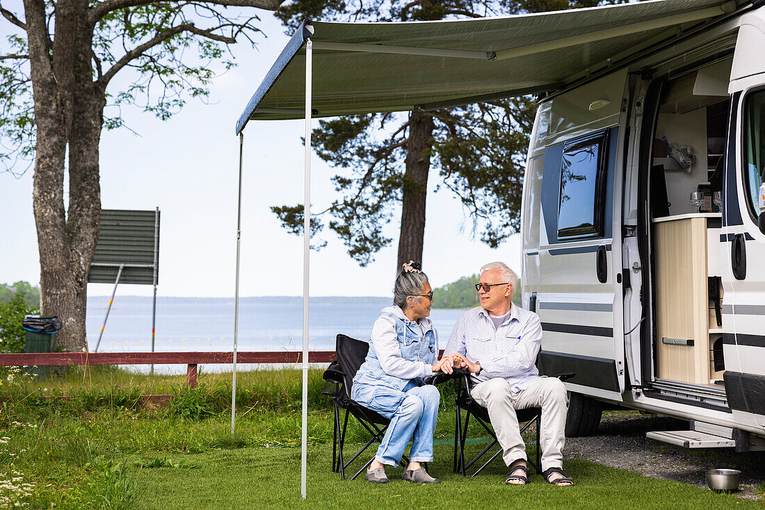 Senior couple camping by sea