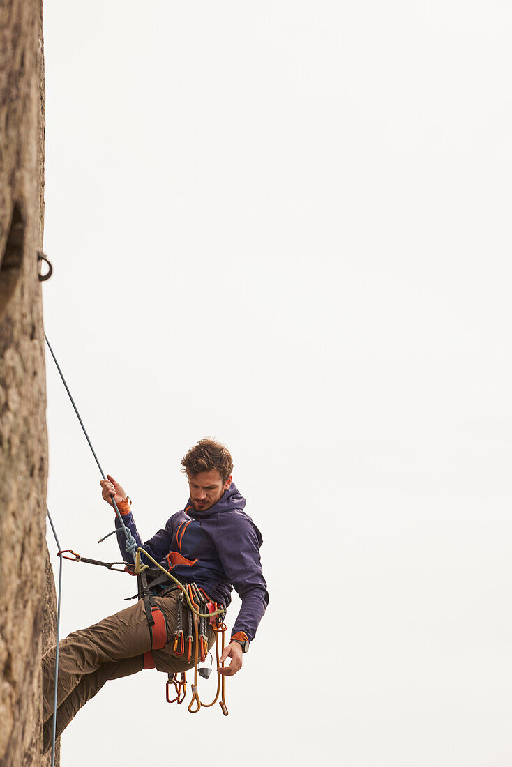 Young man rock climbing