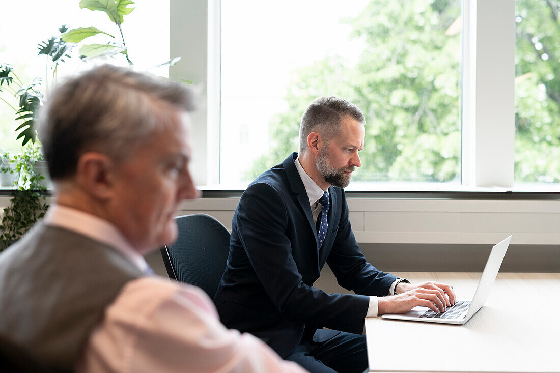 Businessman using laptop in office