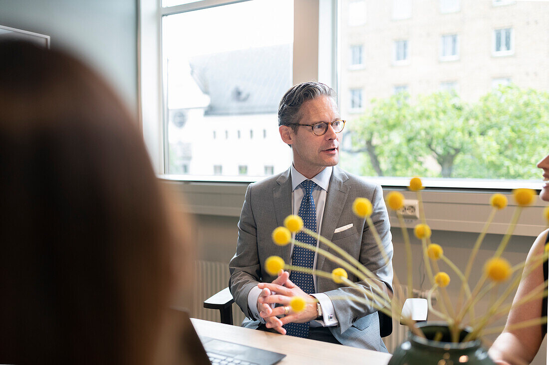 Businessman sitting in office at business meeting