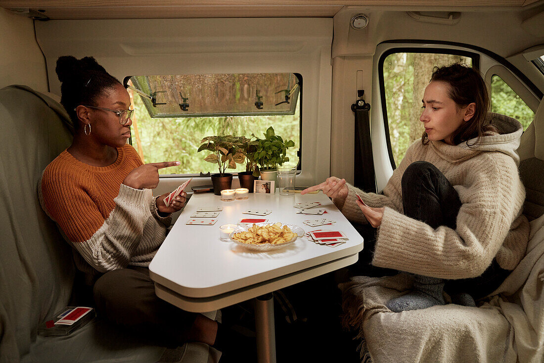Friends playing cards in camper van