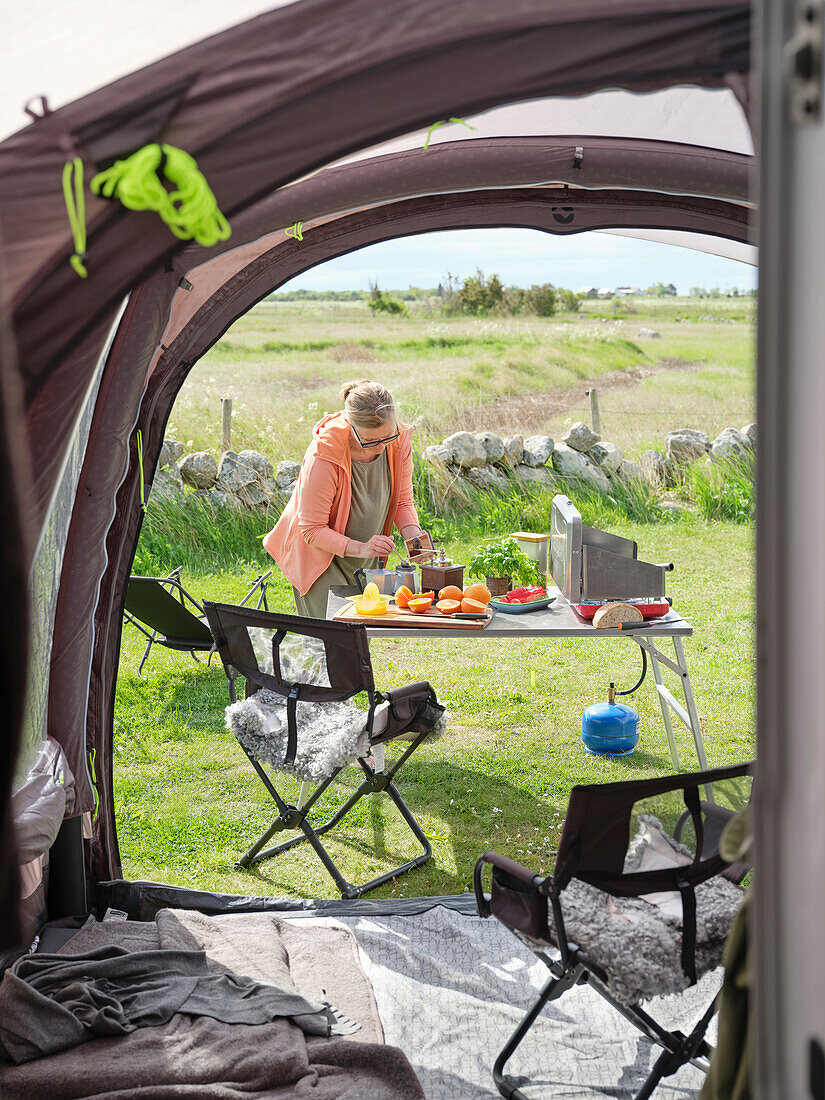 Woman preparing food in front of tent