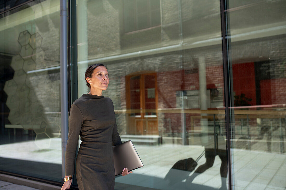 Businesswoman walking, office building in background