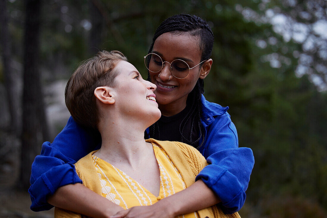 Female couple hugging outdoors