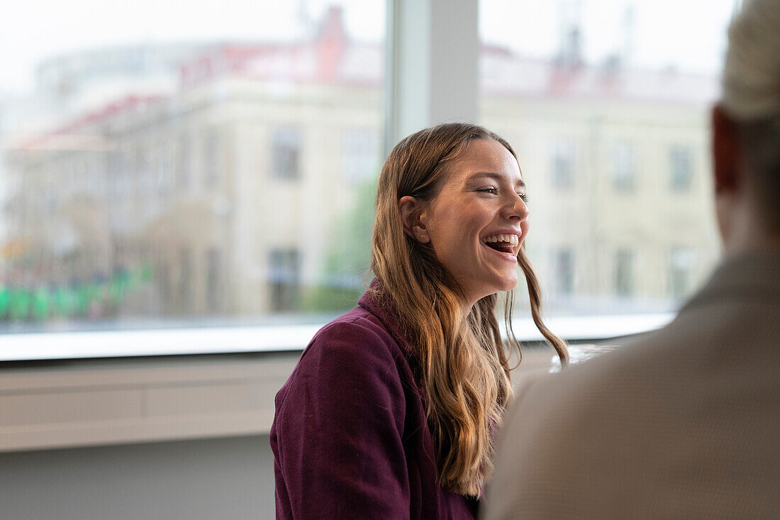 Laughing businesswoman in office