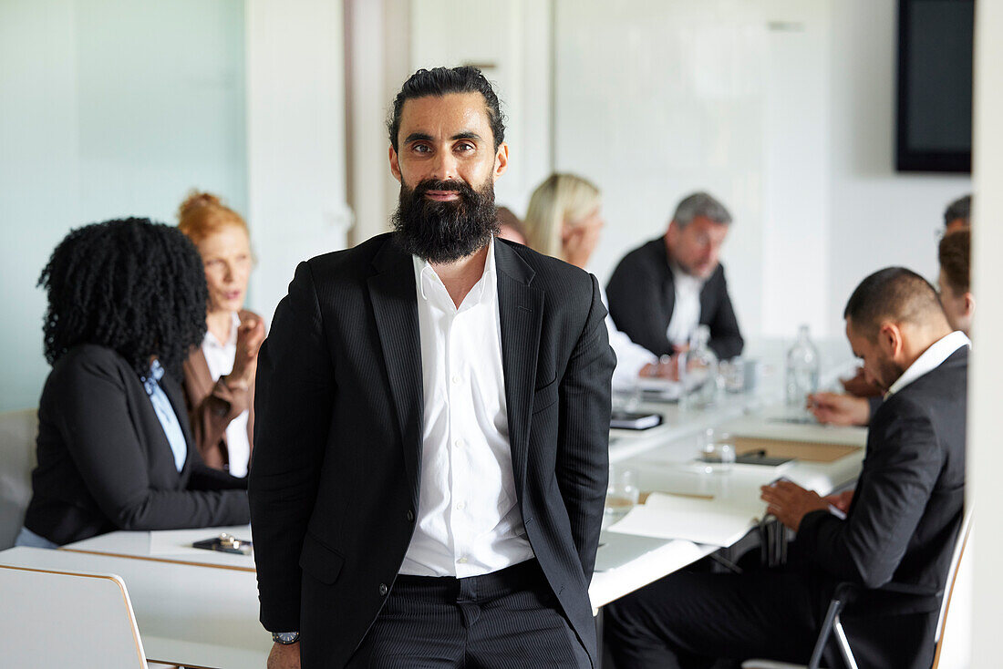 Businessman in boardroom looking at camera