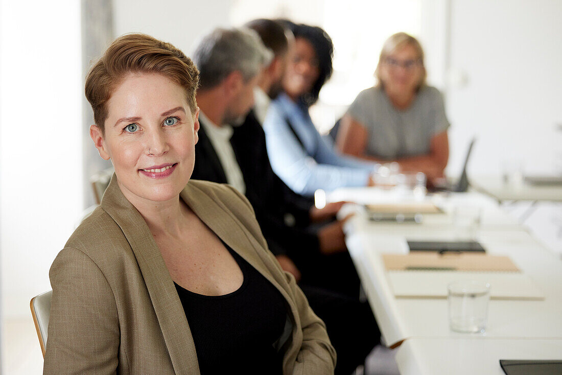 Smiling businesswoman in boardroom