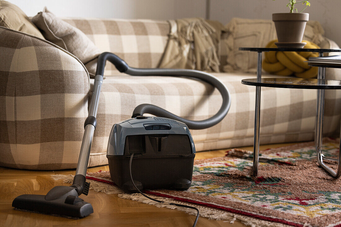 Old-fashioned vacuum cleaner in living room