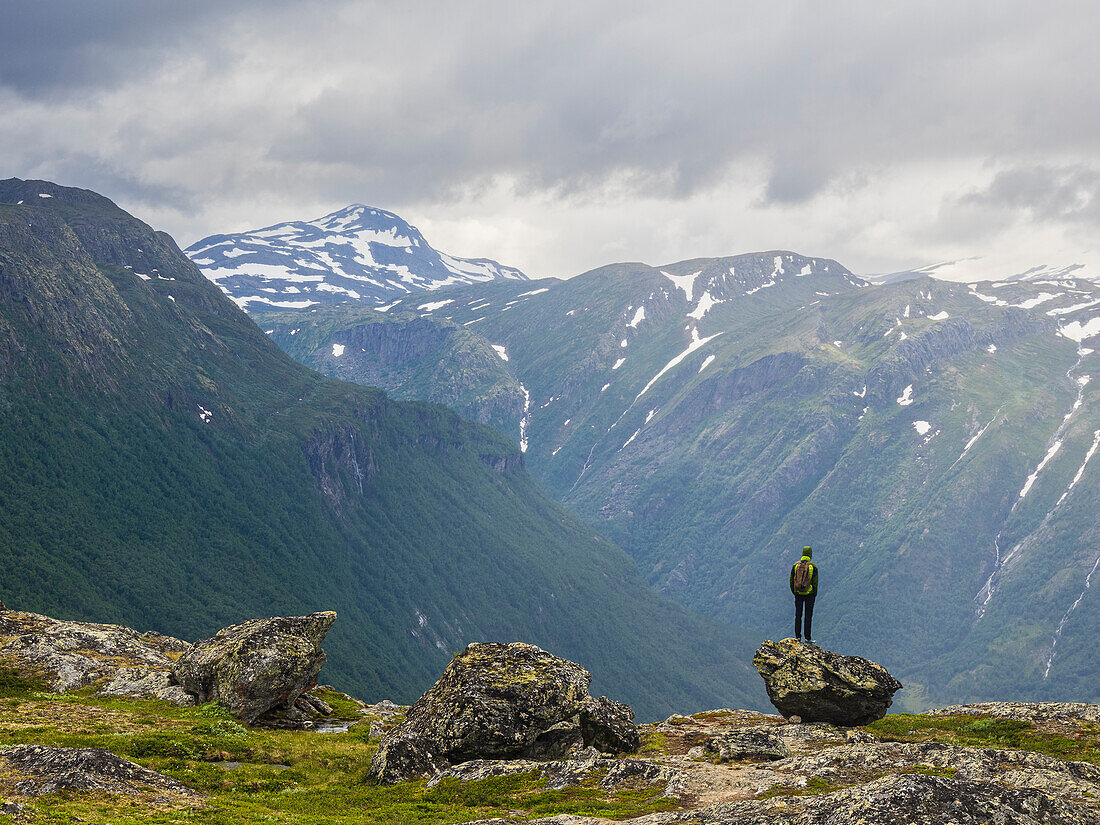 Hiker in mountains looking at view