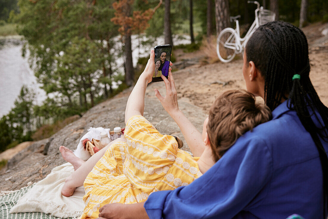 Female couple taking selfie outdoors