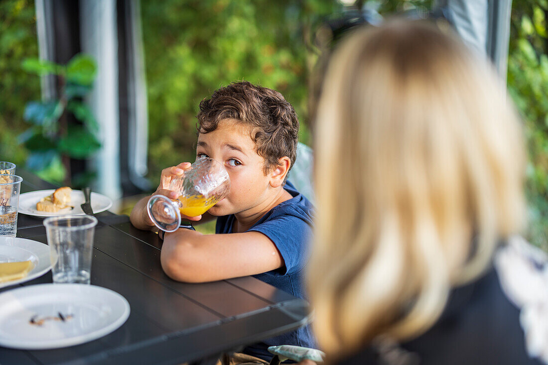 Boy drinking juice at table