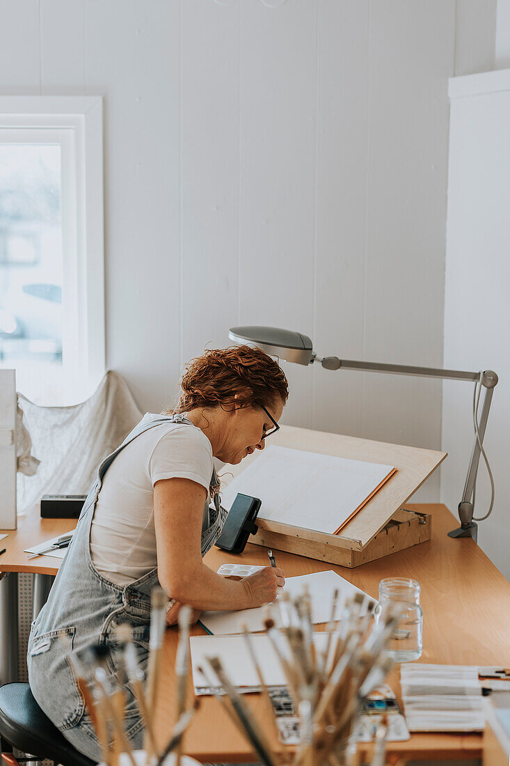 Artist painting in studio