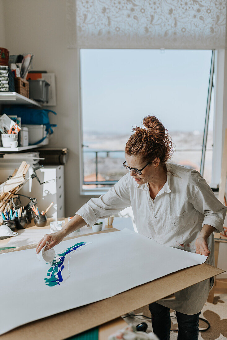 Artist painting in studio