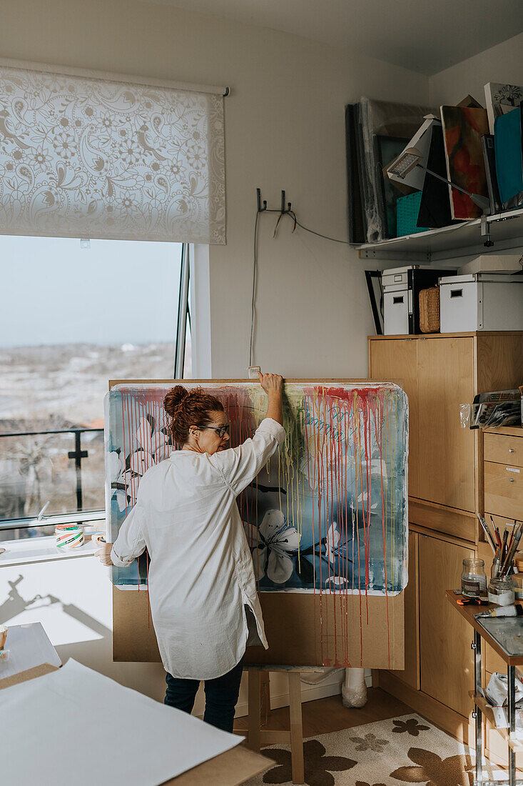 Artist preparing painting in studio