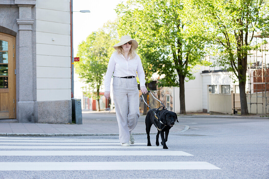 Woman walking with assistance dog