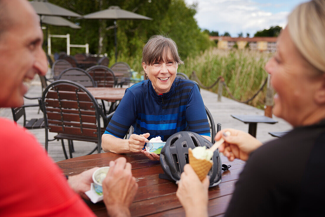 Smiling friends having ice-cream