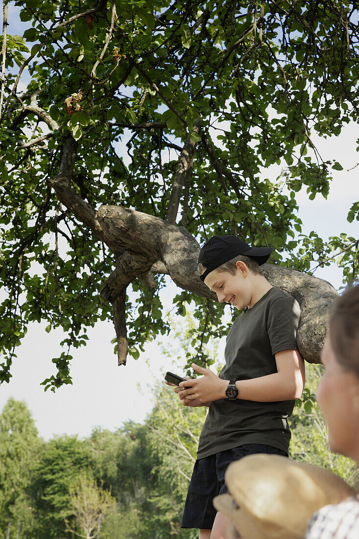 Smiling boy using cell phone