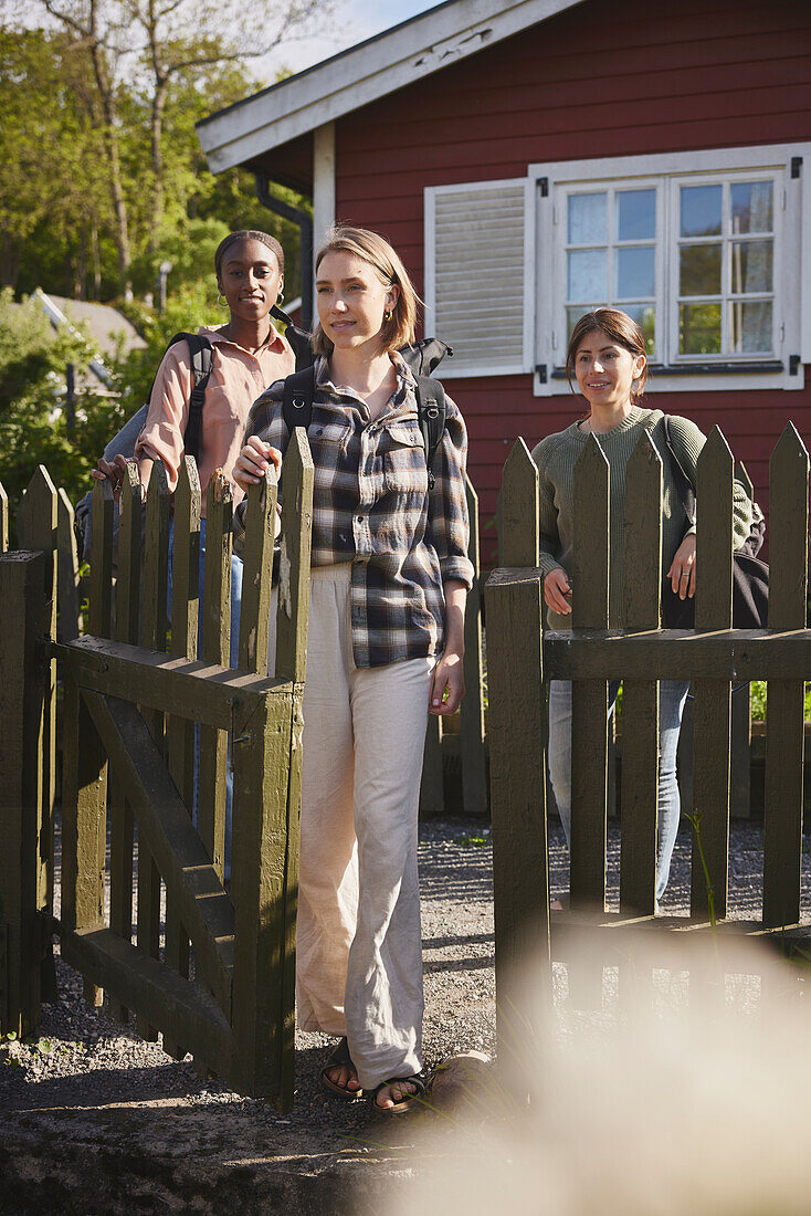 Female friends at wooden fence