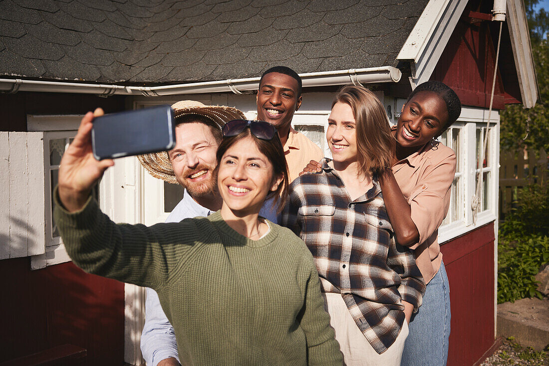 Smiling friends taking selfie