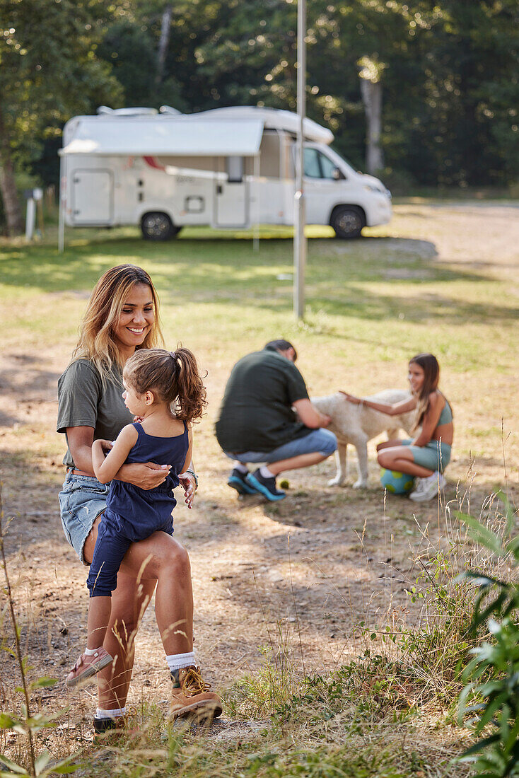 Mother with daughter at camping site