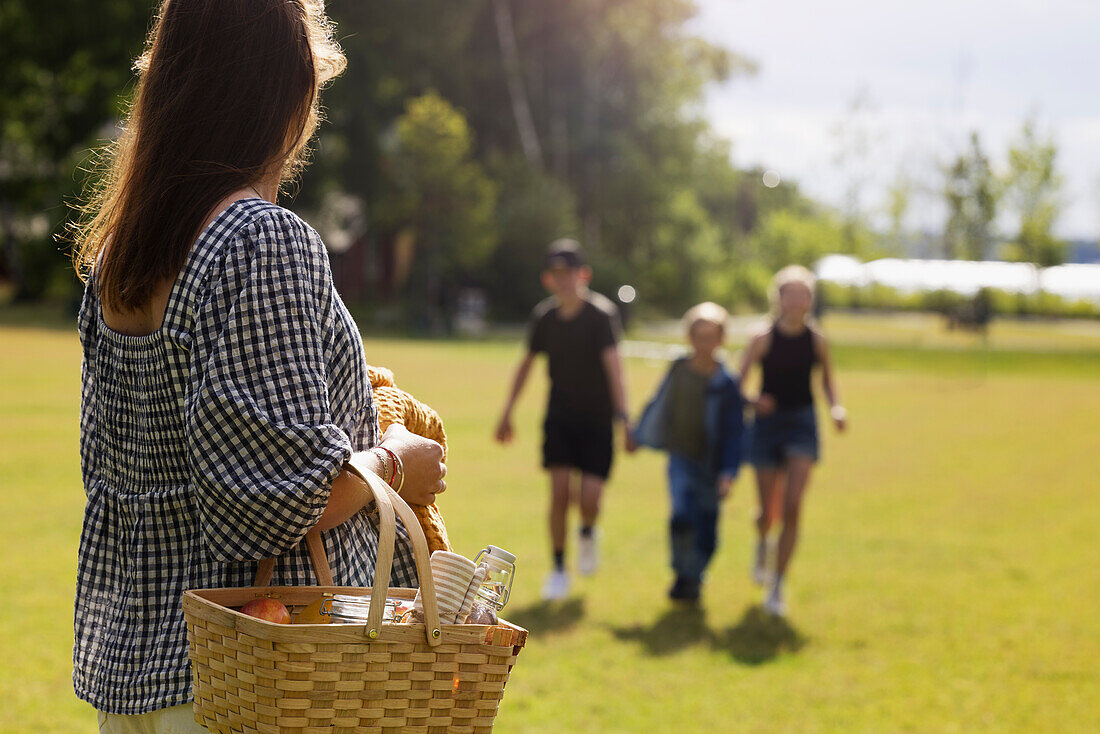 Woman with wicker basket looking away