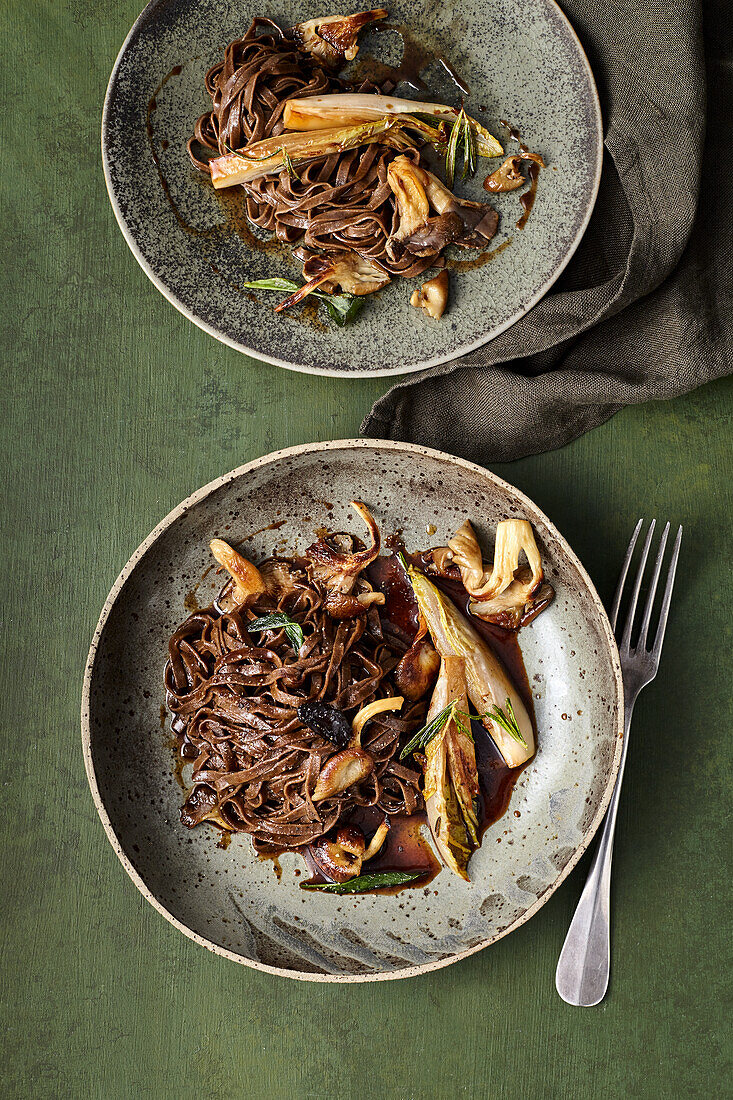 Black-garlic tagliatelle with mushroom sauce and chicory