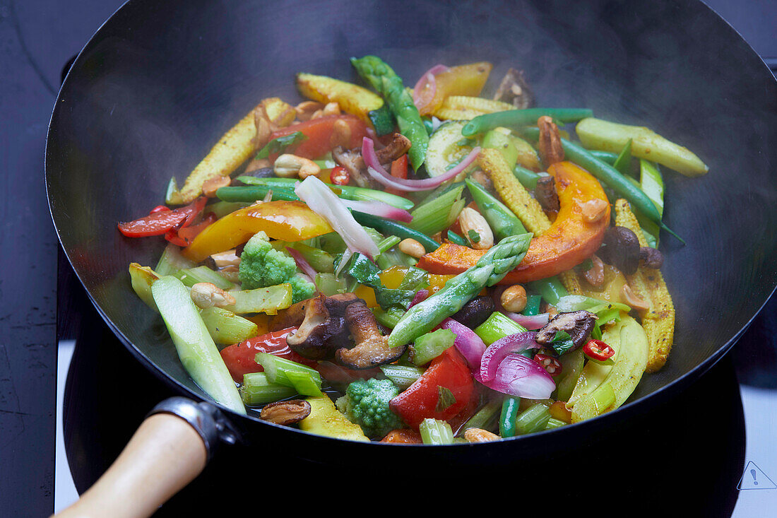 Colorful vegetables cooking in a wok
