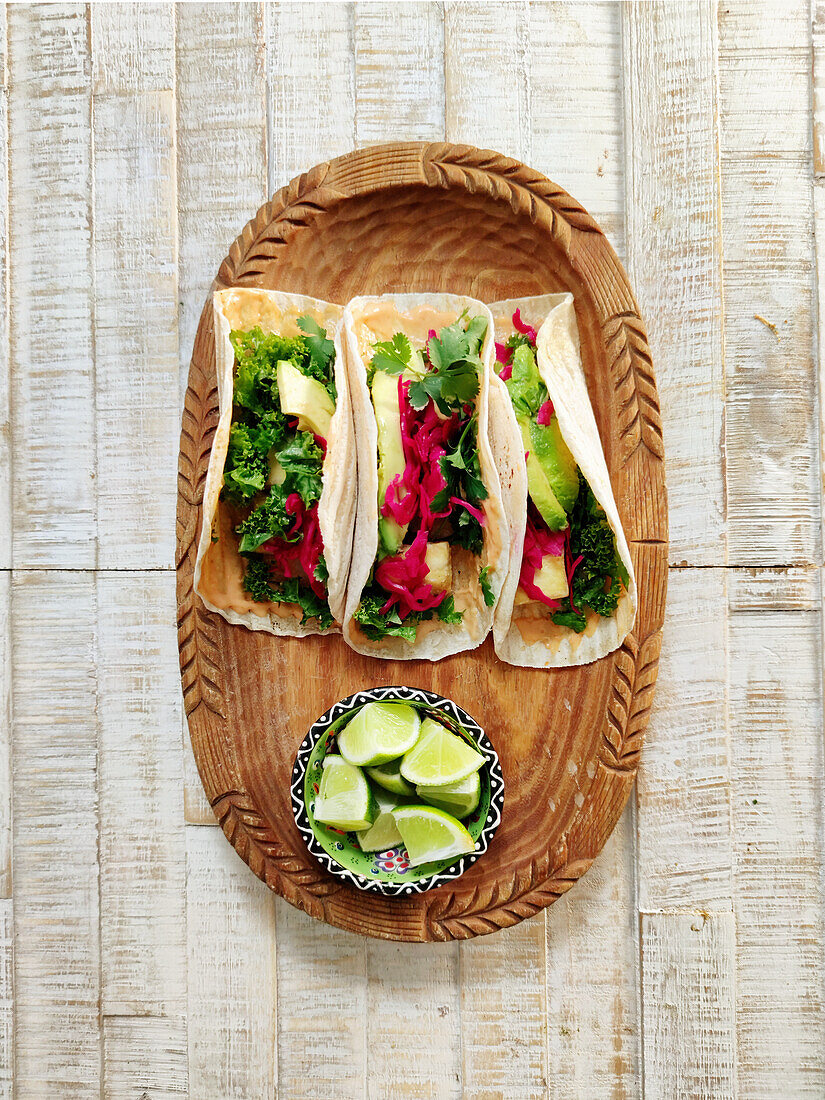 Veggie tacos with hummus, kale and avocado