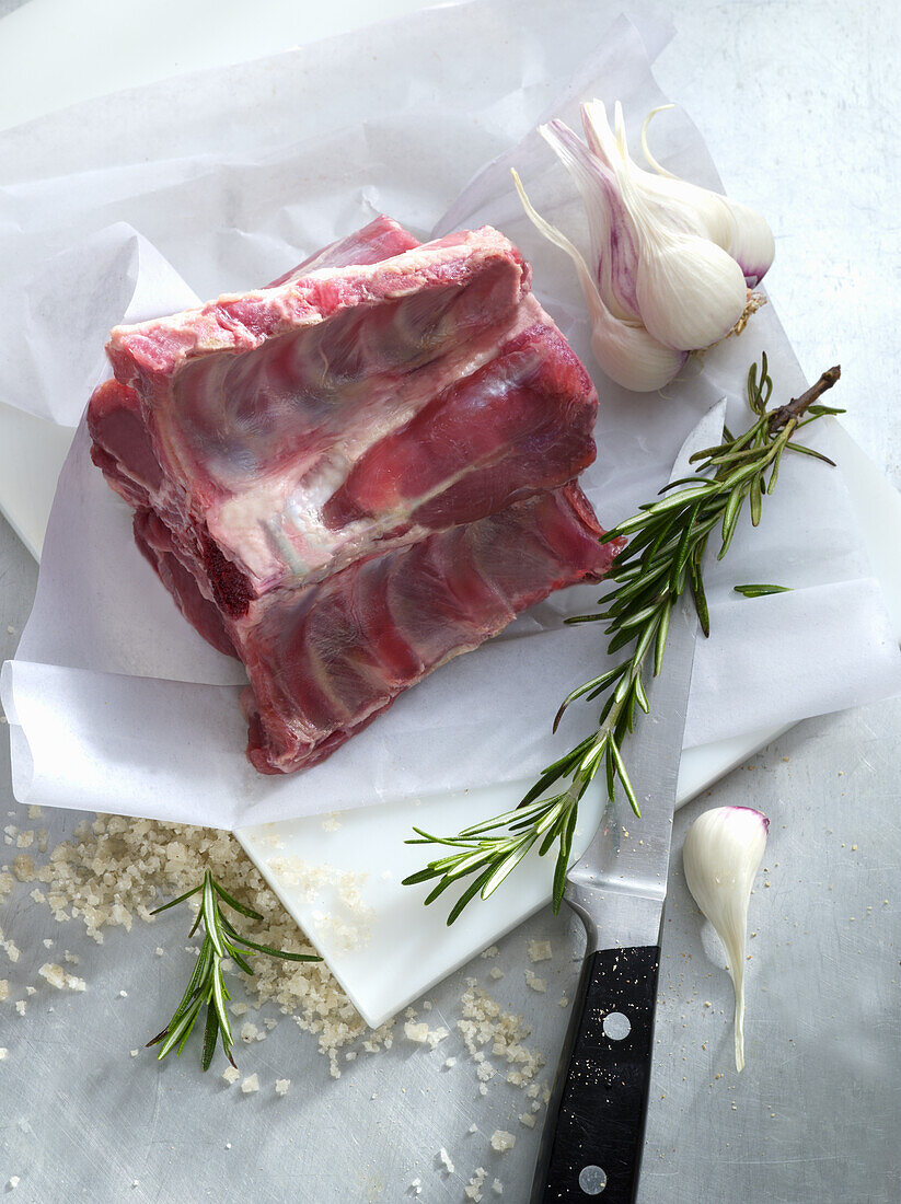 Raw rack of lamb with garlic and rosemary