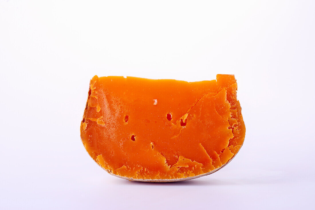 A piece of mimolette cheese