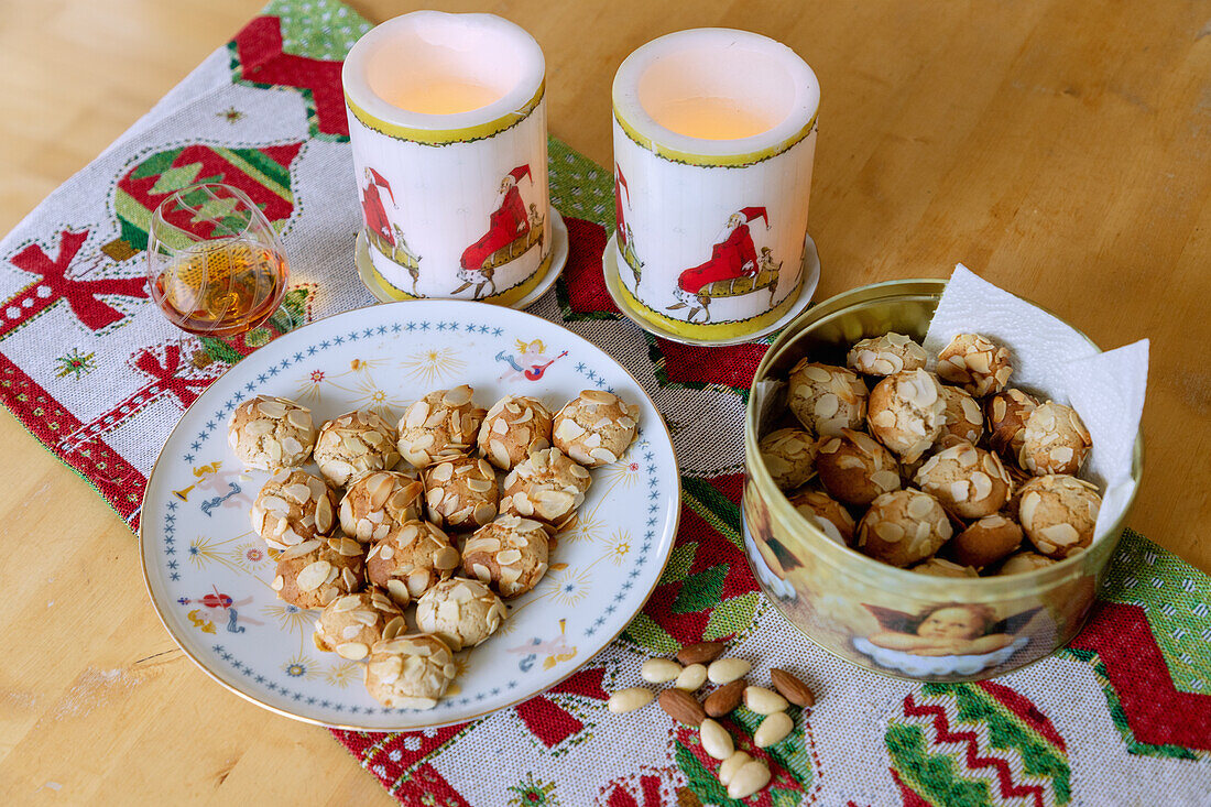 Sicilian almond cookies on a Christmas plate and in a tin