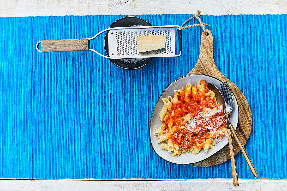 Penne with pumpkin-tomato sauce; parmesan cheese