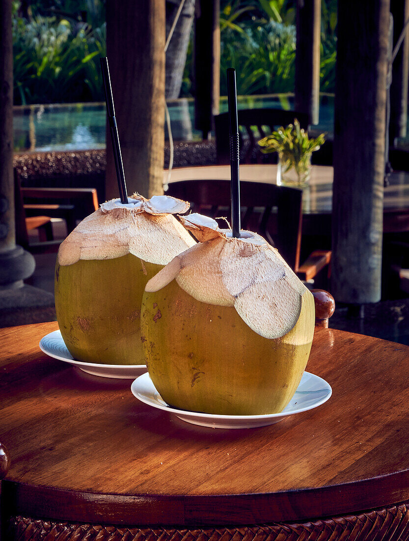 Coconut with straw on restaurant table (Seychelles)
