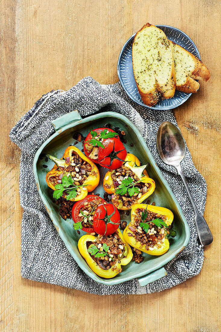 Stuffed tomatoes and peppers with garlic bread