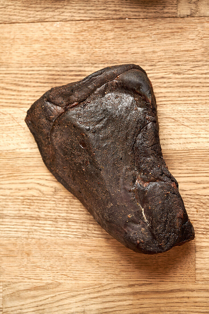 Cured Deer ham on a wooden background