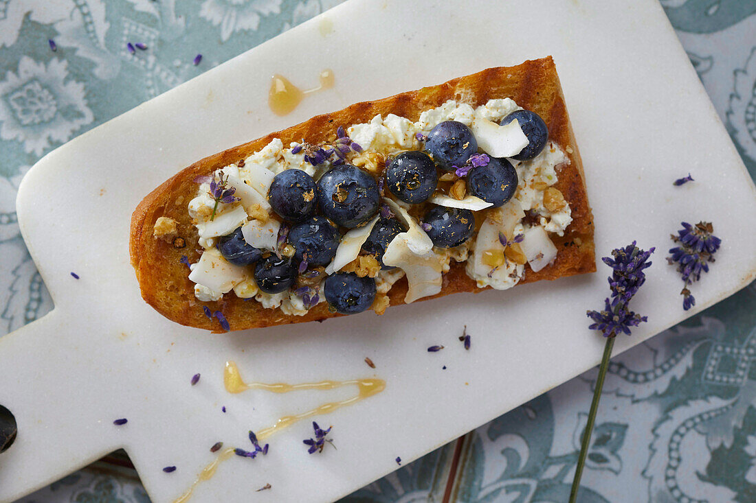 Baguette with cottage cheese, blueberries and coconut shavings