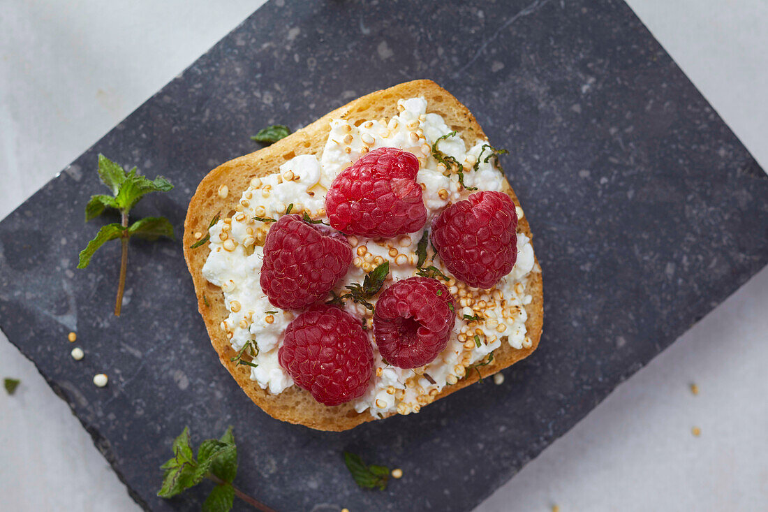Light organic bread with cottage cheese, quinoa and raspberries