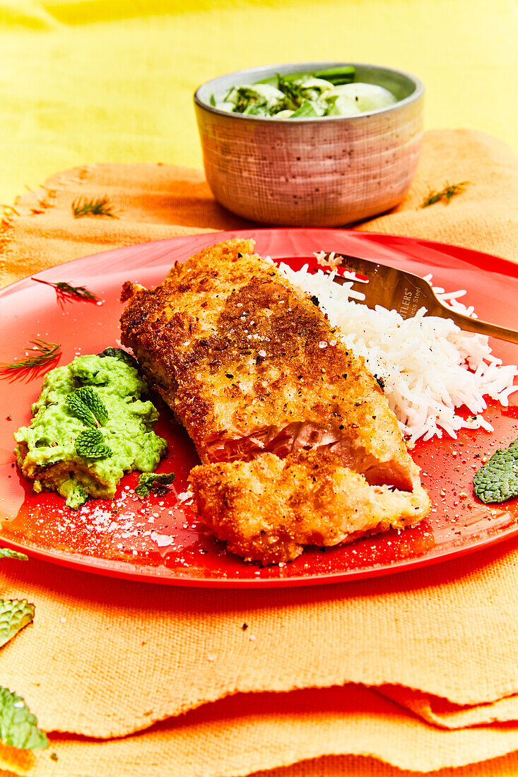 Juicy salmon in coconut breading with rice